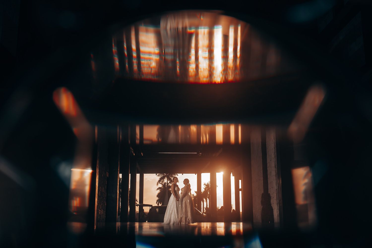 Dramatic silhouette of interior window frames with warm sunlight streaming through.
