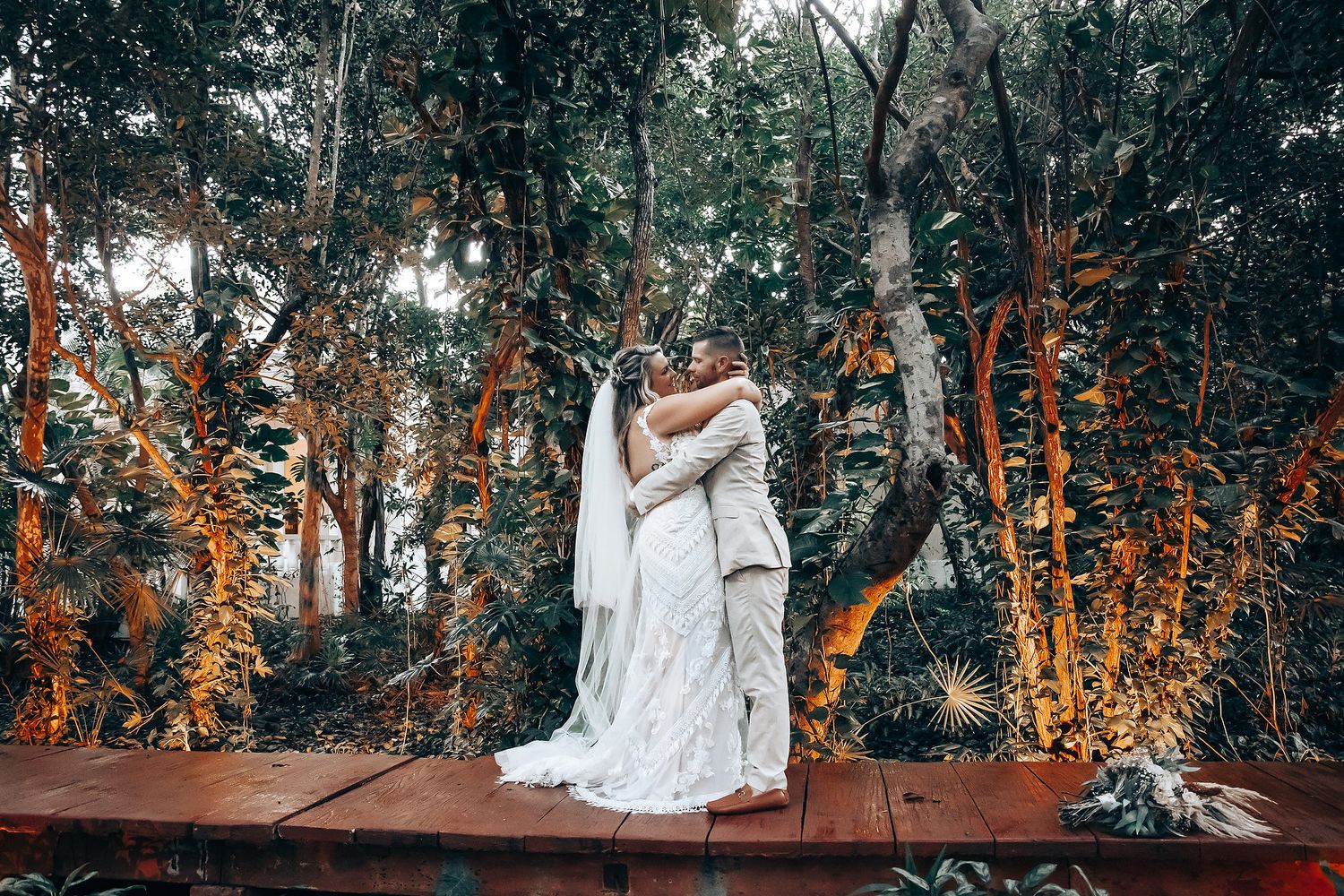 Romantic woodland wedding setting with natural foliage and warm autumn lighting.