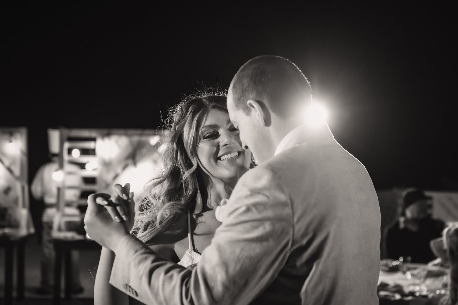 An intimate dance moment captured in dramatic black and white lighting.