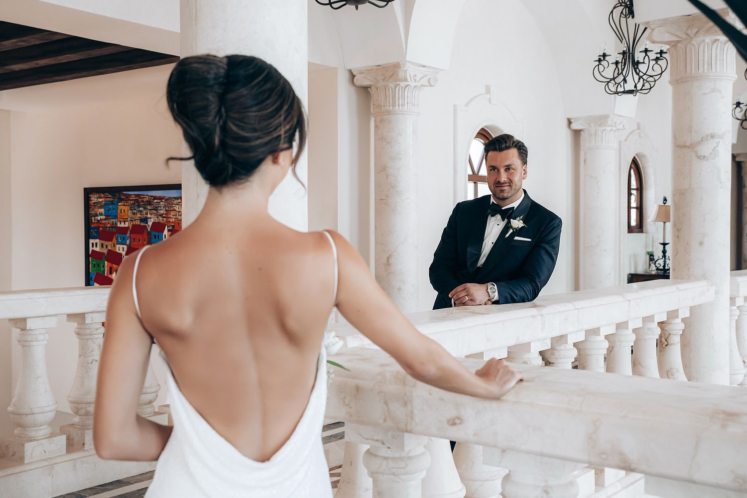 A series of candid wedding moments captured in a light-filled venue with elegant white columns and architecture.