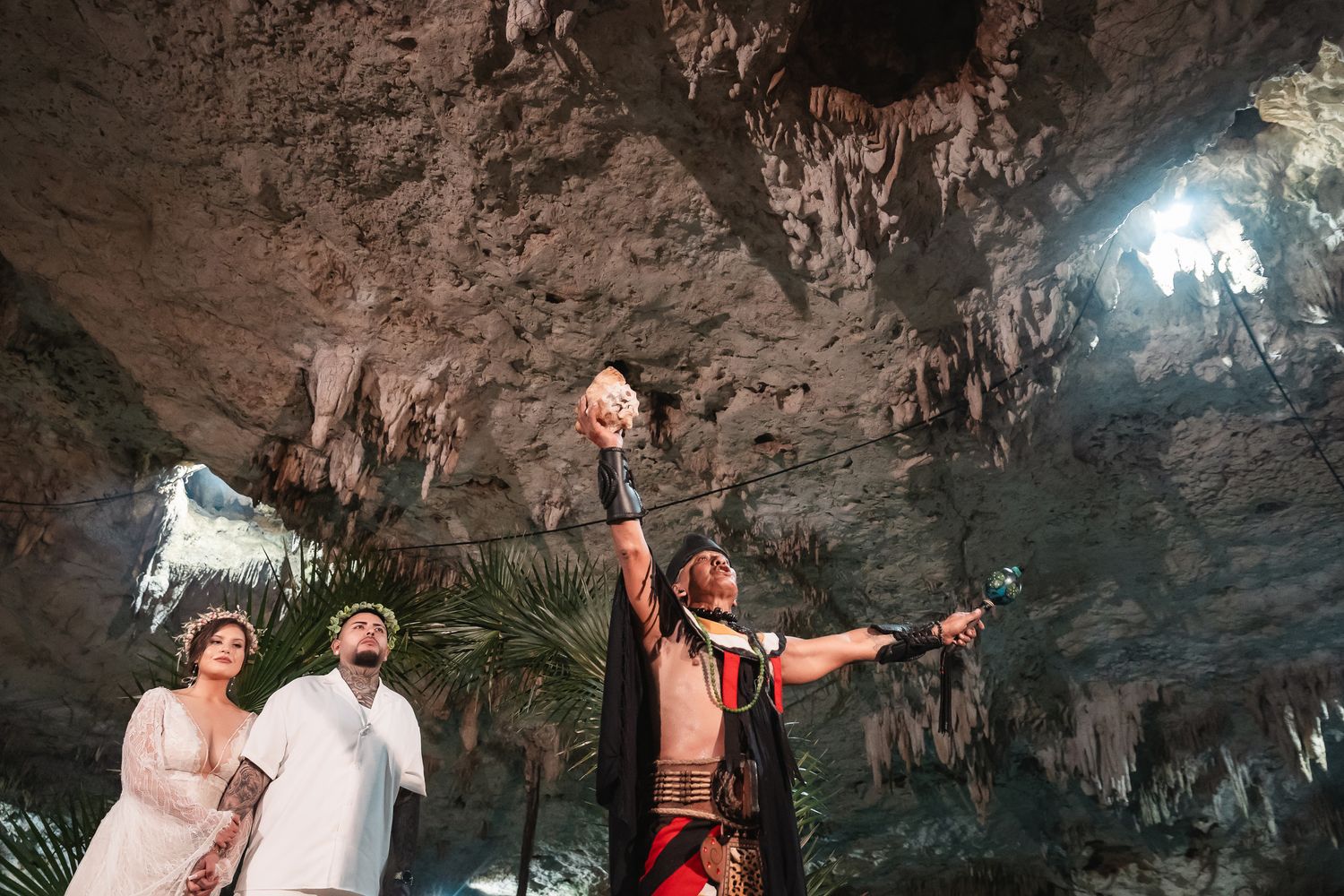 Underground cave wedding ceremony with dramatic rock formations and natural lighting.