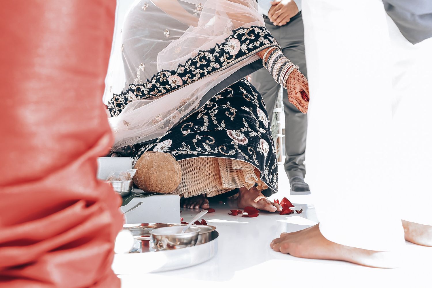 Collage of feet and legs dancing on a white floor during a lively celebration.