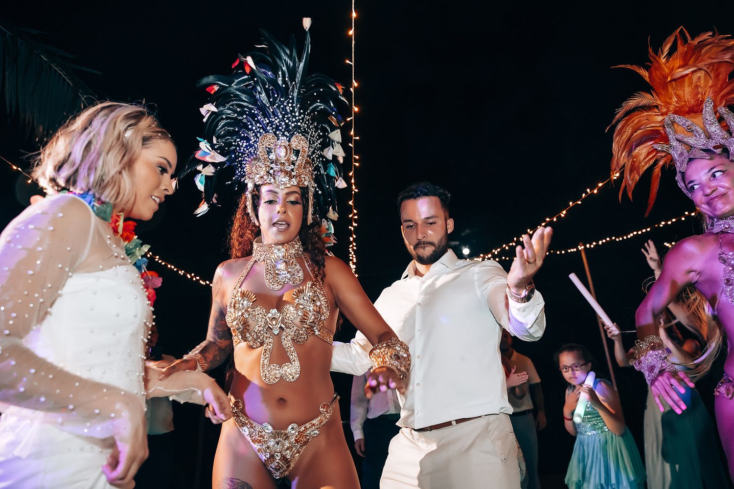 Wedding reception dance party with colorful lighting and festive decorations.