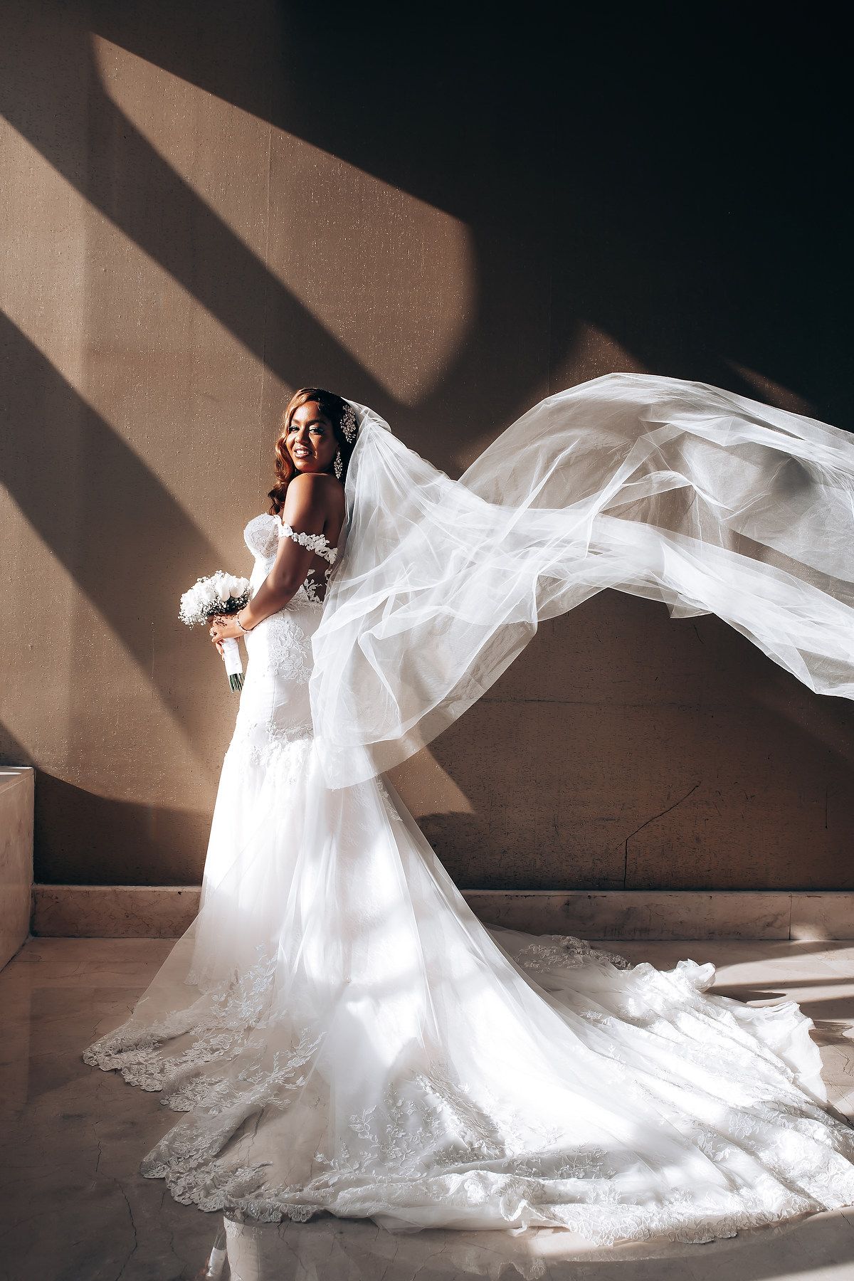 Artistic bridal portraits showing flowing white wedding dress movement against dramatic lighting and shadows.