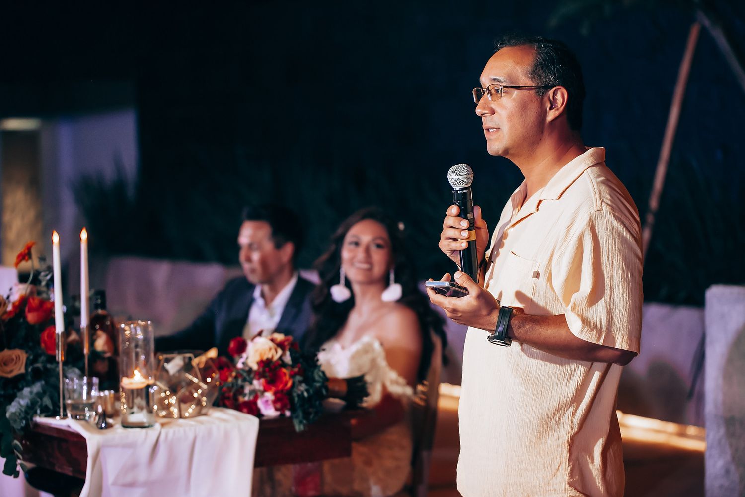 Speaker addresses guests during evening reception dinner.