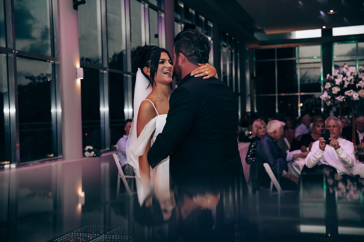 Wedding reception in elegant venue with dark lighting and romantic atmosphere.