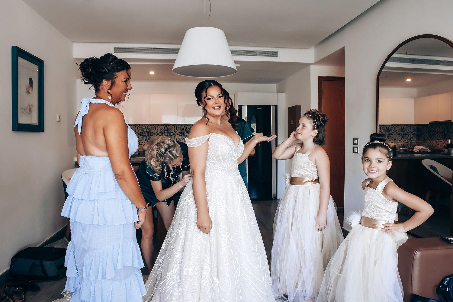 A series of wedding preparation photos showing white dresses and floral details.