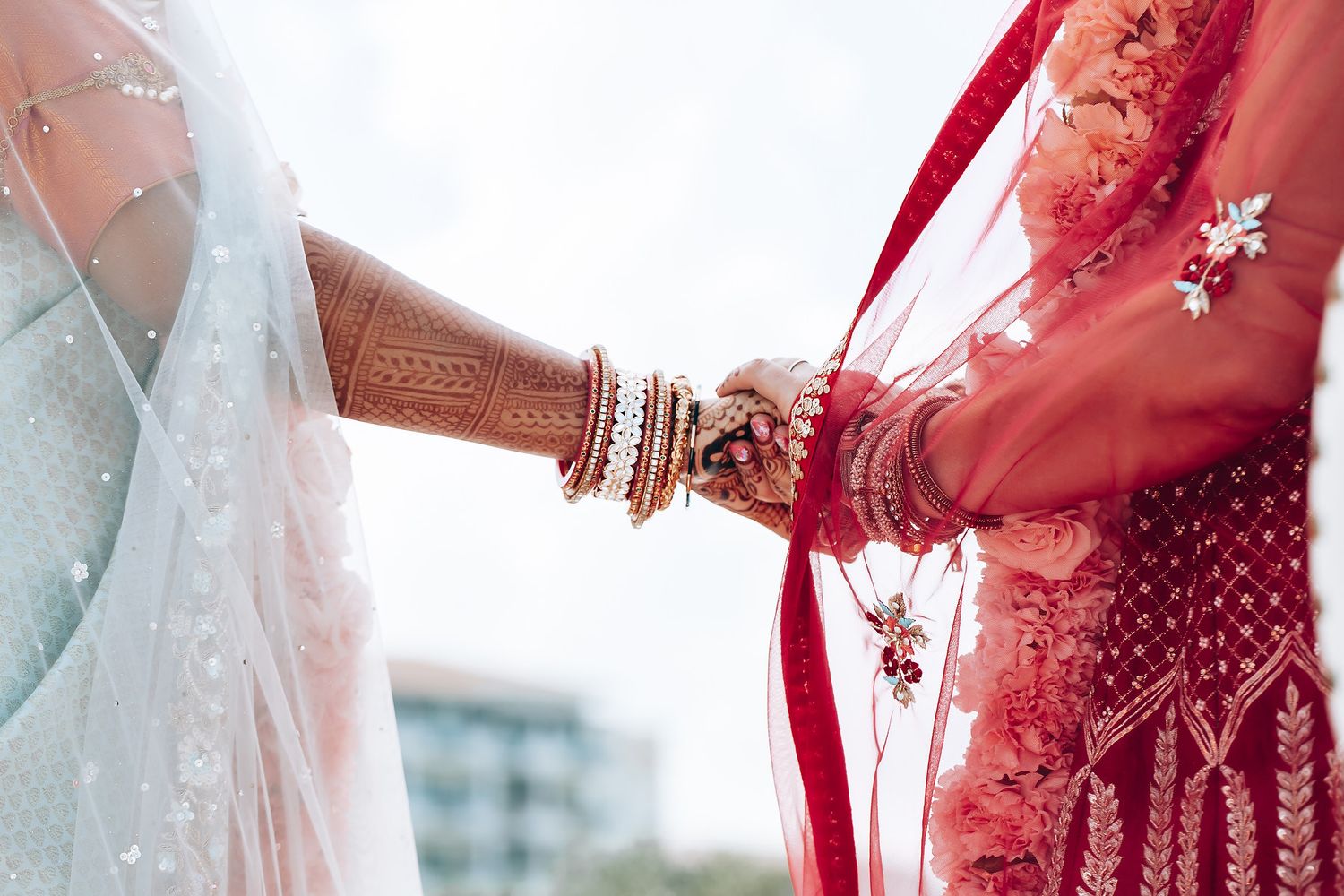 Elegant wedding celebration with red and white decorative elements in an outdoor setting.