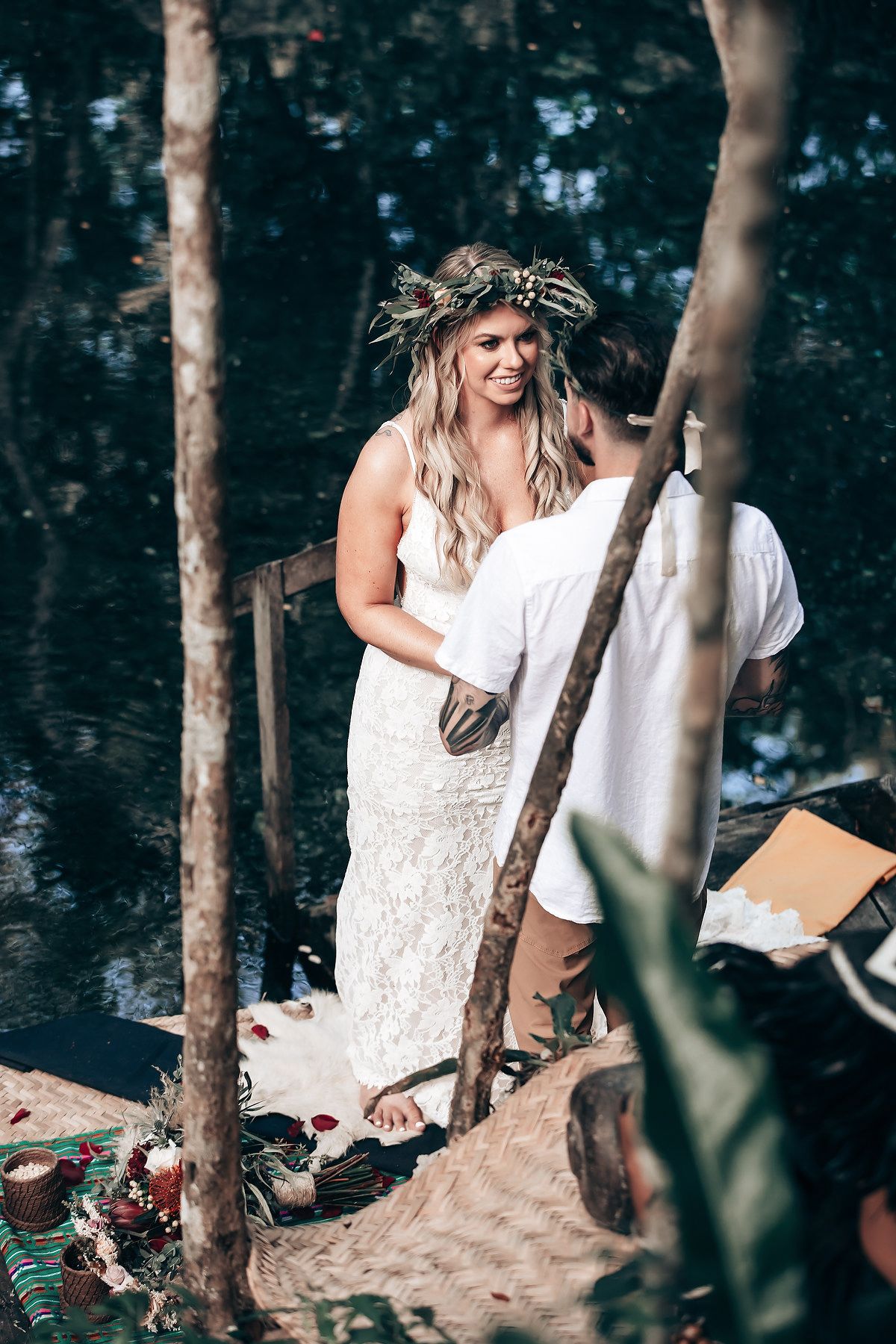 White-dressed figures in a mystical forest setting with natural lighting.