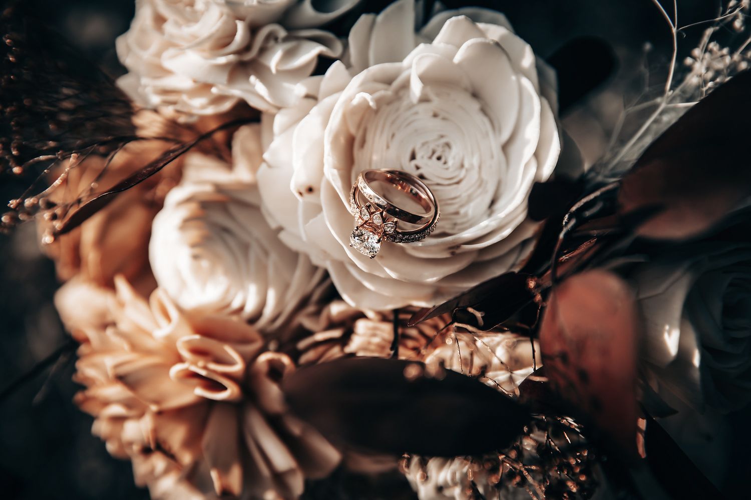 A close-up view of a bouquet of flowers, including roses, in a natural setting.