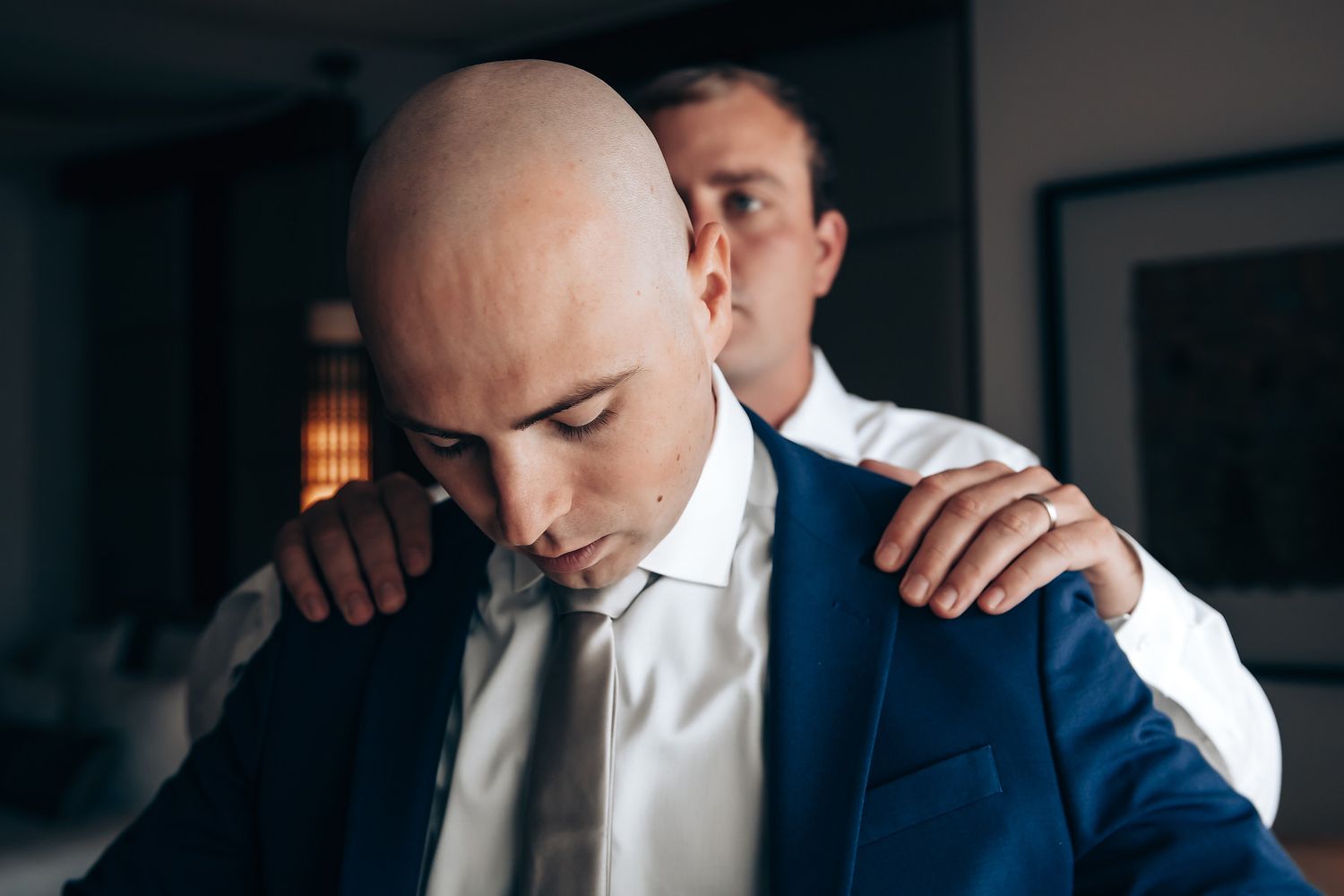 A man comforting another man who appears to be upset or distressed.