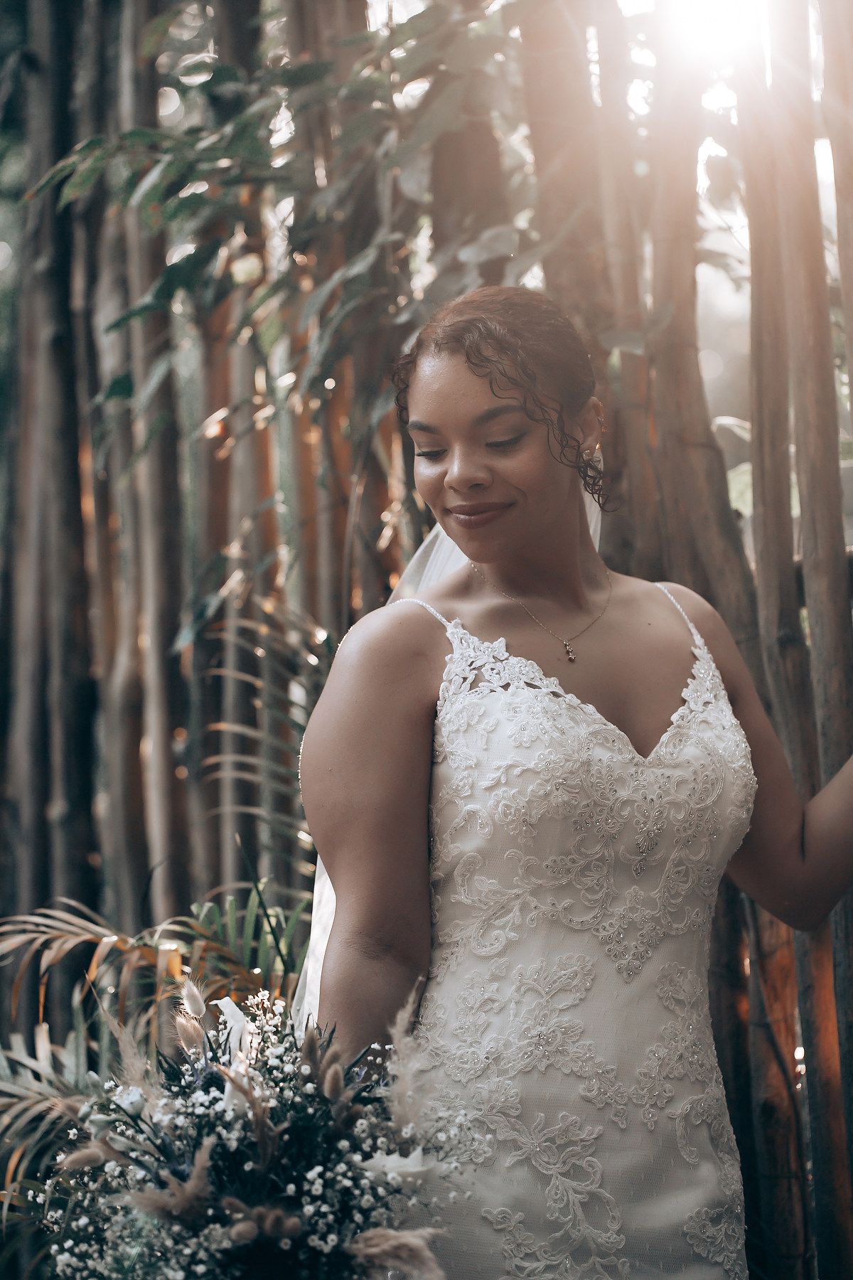 Beautiful lace wedding dress details captured in natural forest lighting.