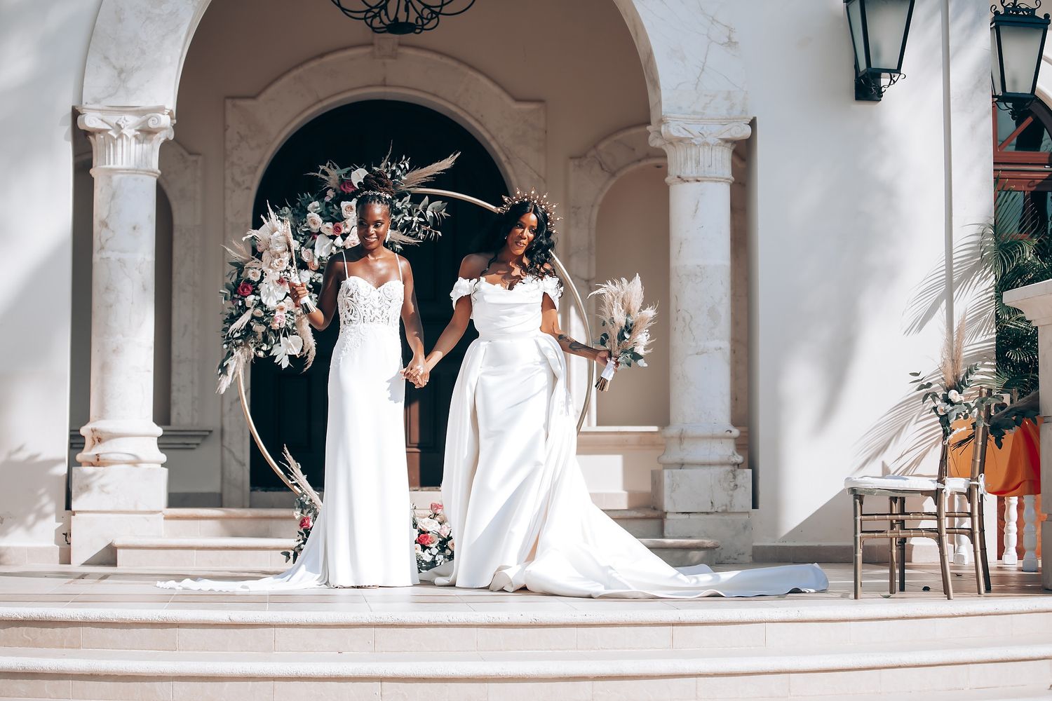 Mediterranean-style wedding venue with white columns and elegant floral arrangements.