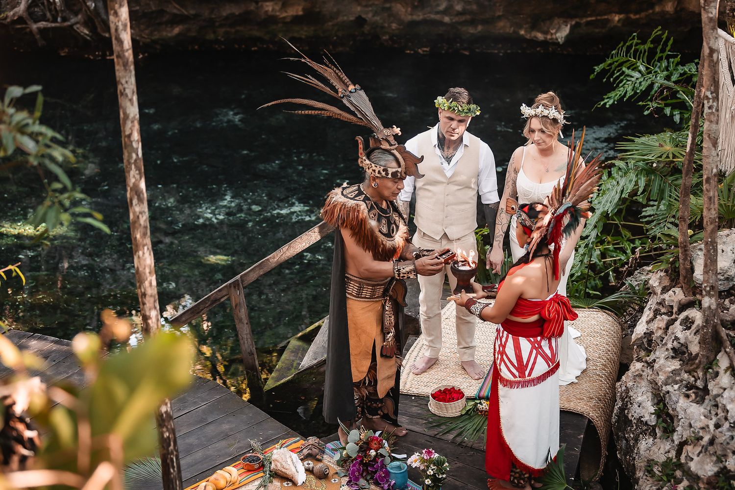 Traditional Mayan wedding ceremony being conducted in a scenic cenote location.