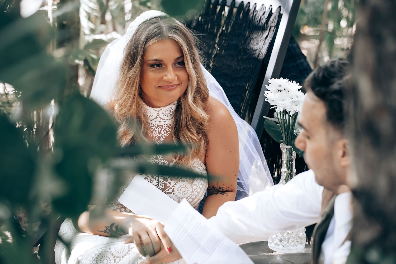 Intimate wedding photography capturing candid moments in a natural outdoor setting.