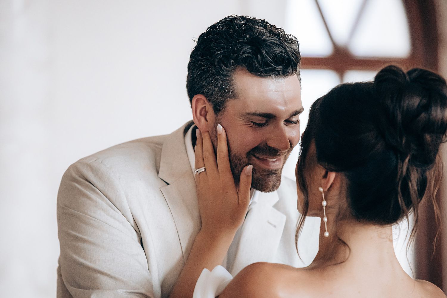 Intimate black and white photo series showing tender moments between a couple in white attire.