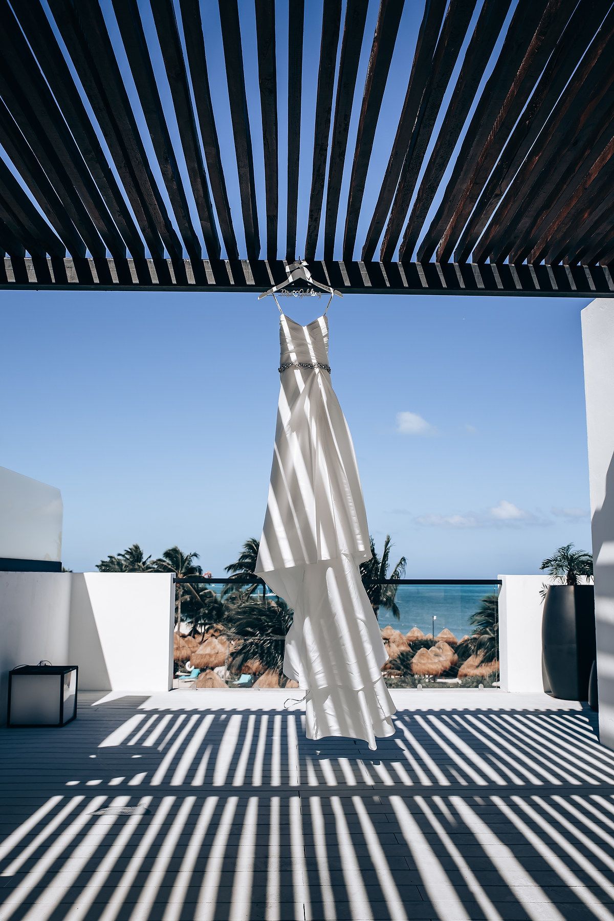 Architectural series showing dramatic shadows cast by white slanted columns against a modern building exterior.