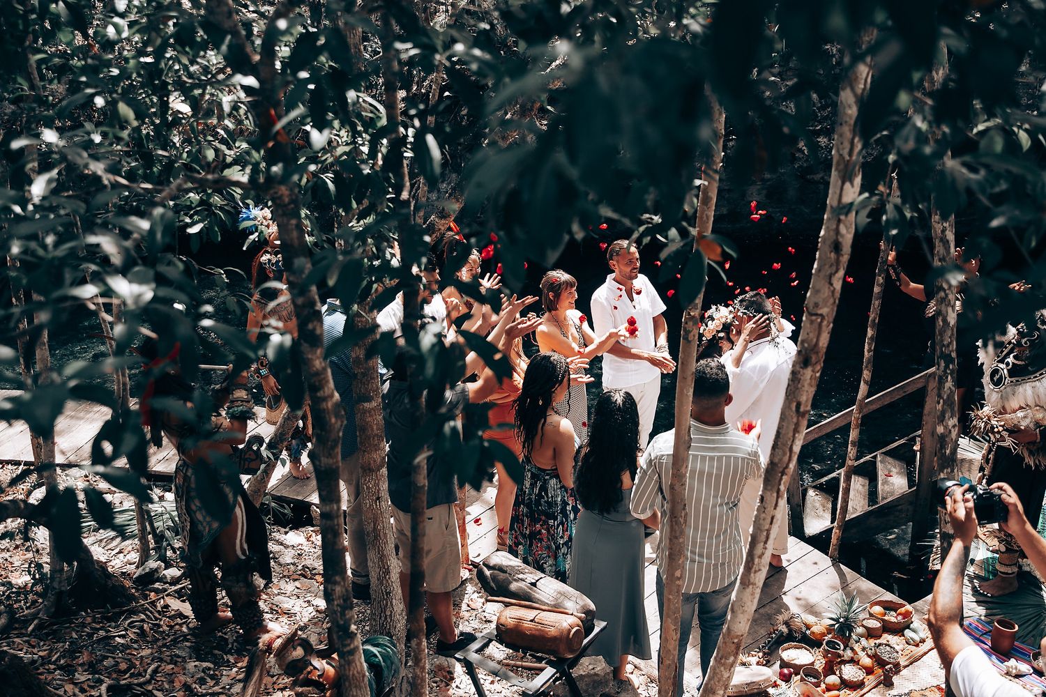 Forest wedding ceremony with guests seated among trees and natural surroundings.