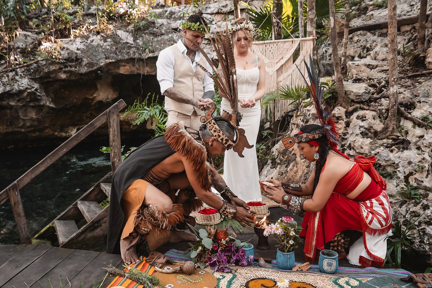 Mayan ceremony wedding ritual at a cenote in Mexico with officiant and couple.