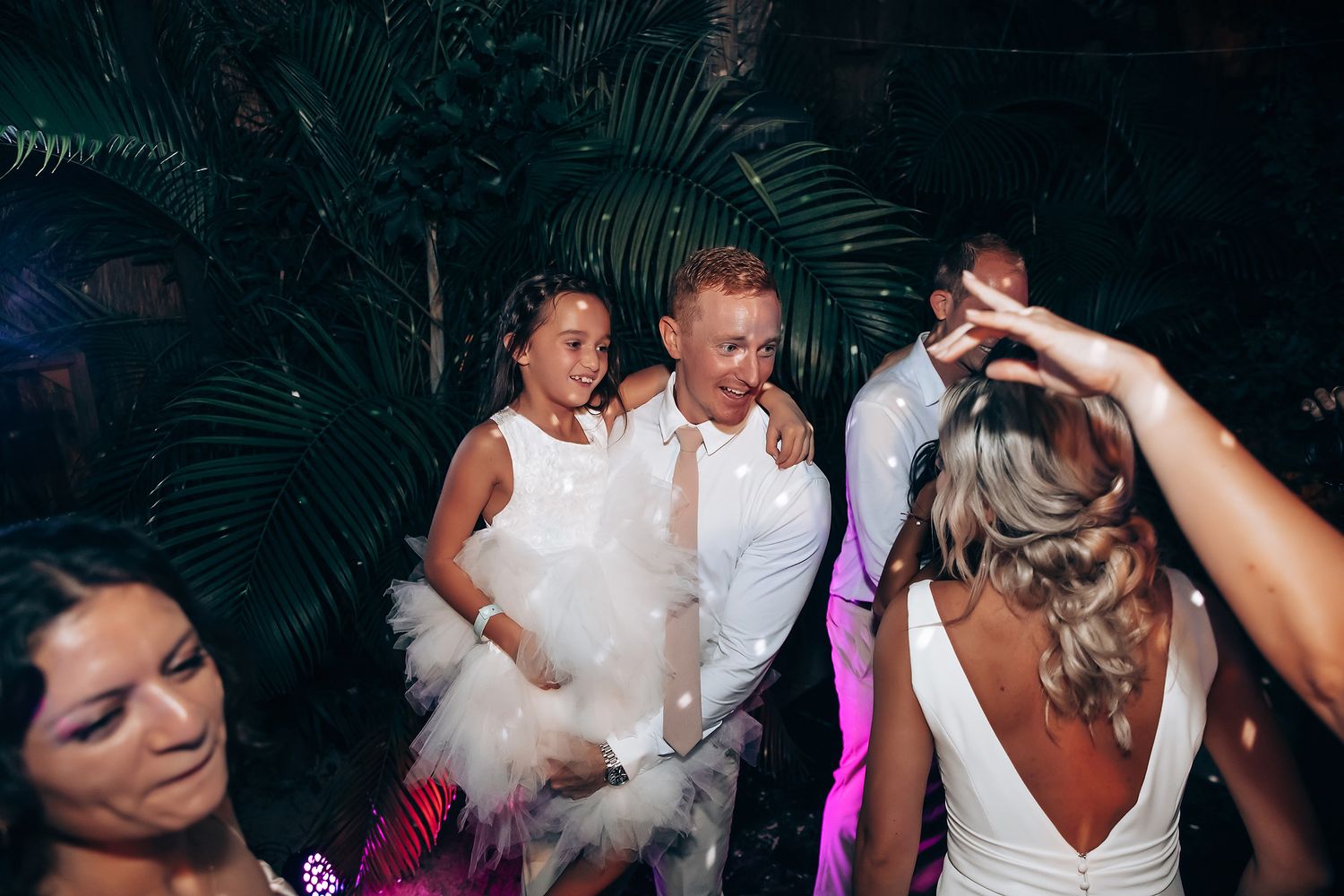 Dance floor celebration with guests enjoying a lively wedding reception party.