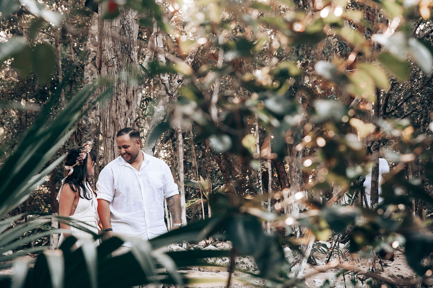 A dreamy forest wedding scene with sunlight filtering through autumn leaves.