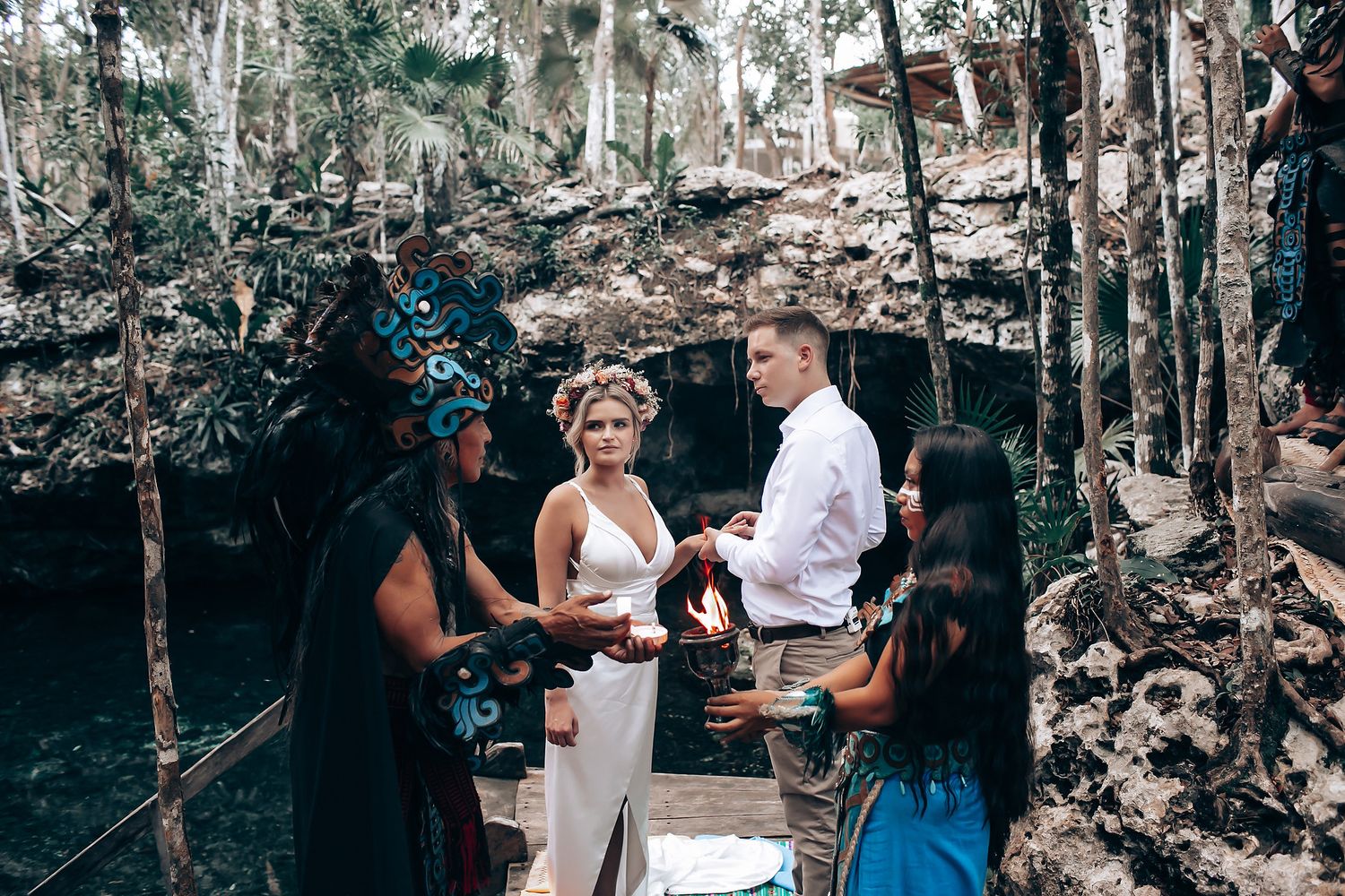 Traditional wedding ceremony being conducted in atmospheric cave setting.