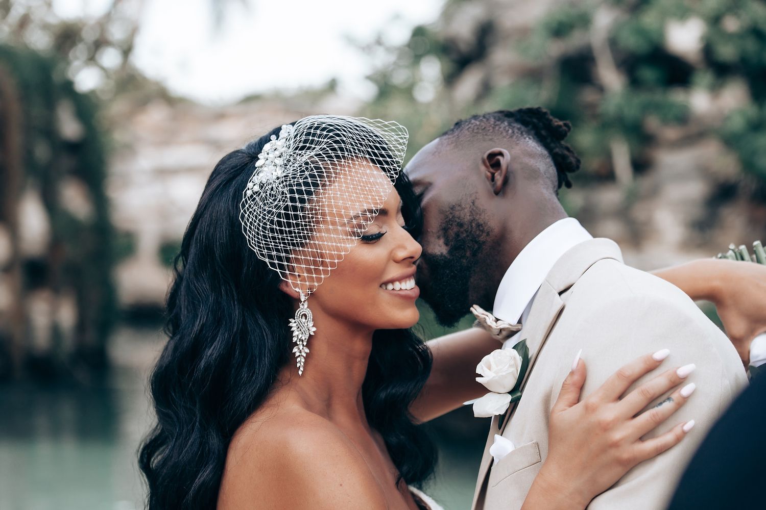 Intimate wedding moment captured with elegant bridal accessories and formal attire.