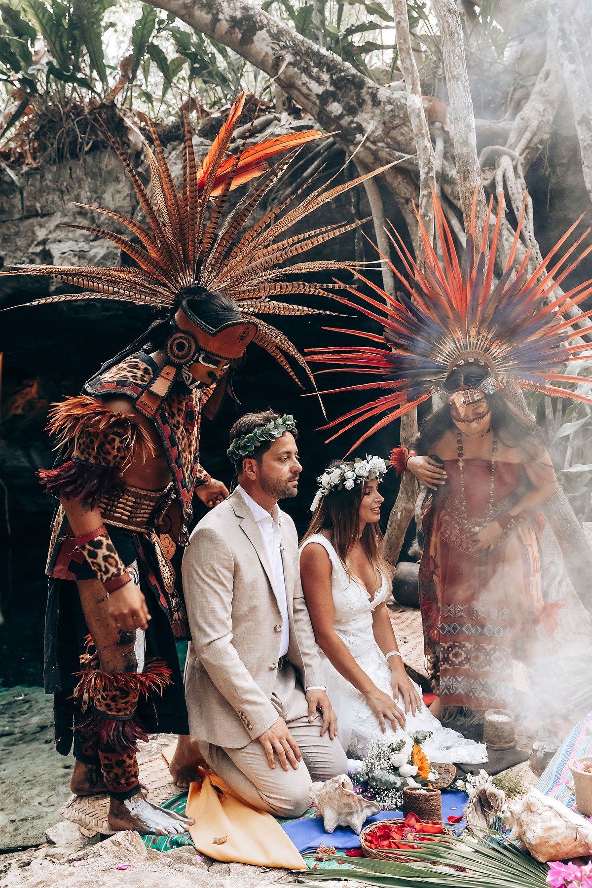 Traditional Aztec dancers in feathered headdresses perform spiritual ceremony outdoors.