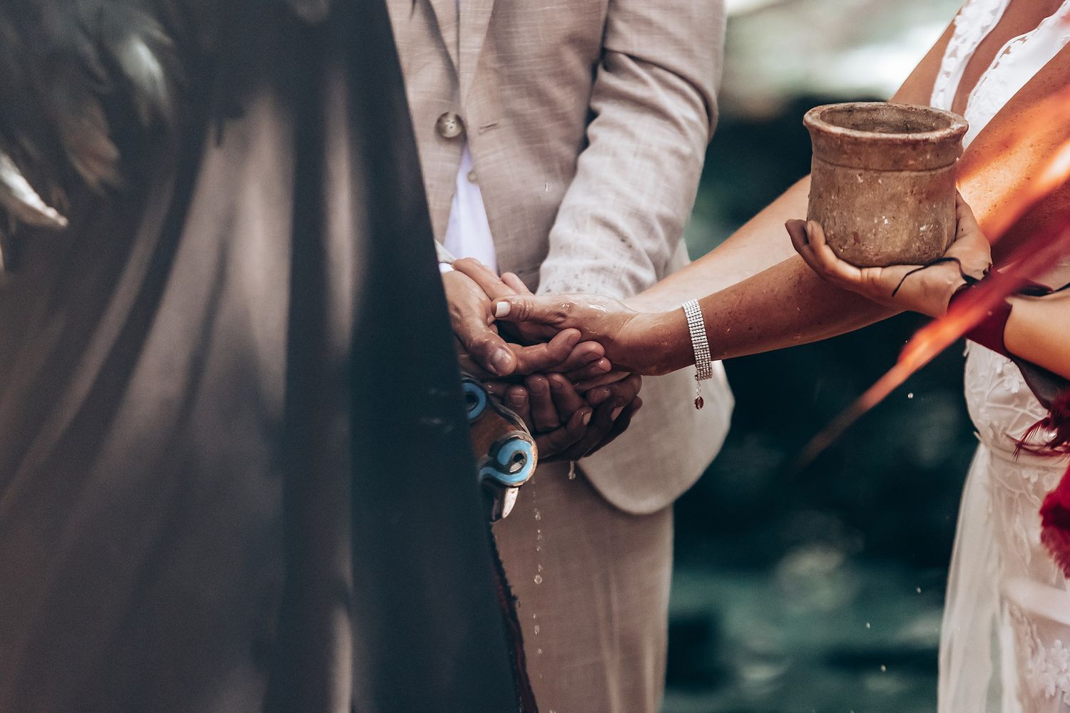 Ceremonial blessing with coconut shells during traditional Mayan ritual.