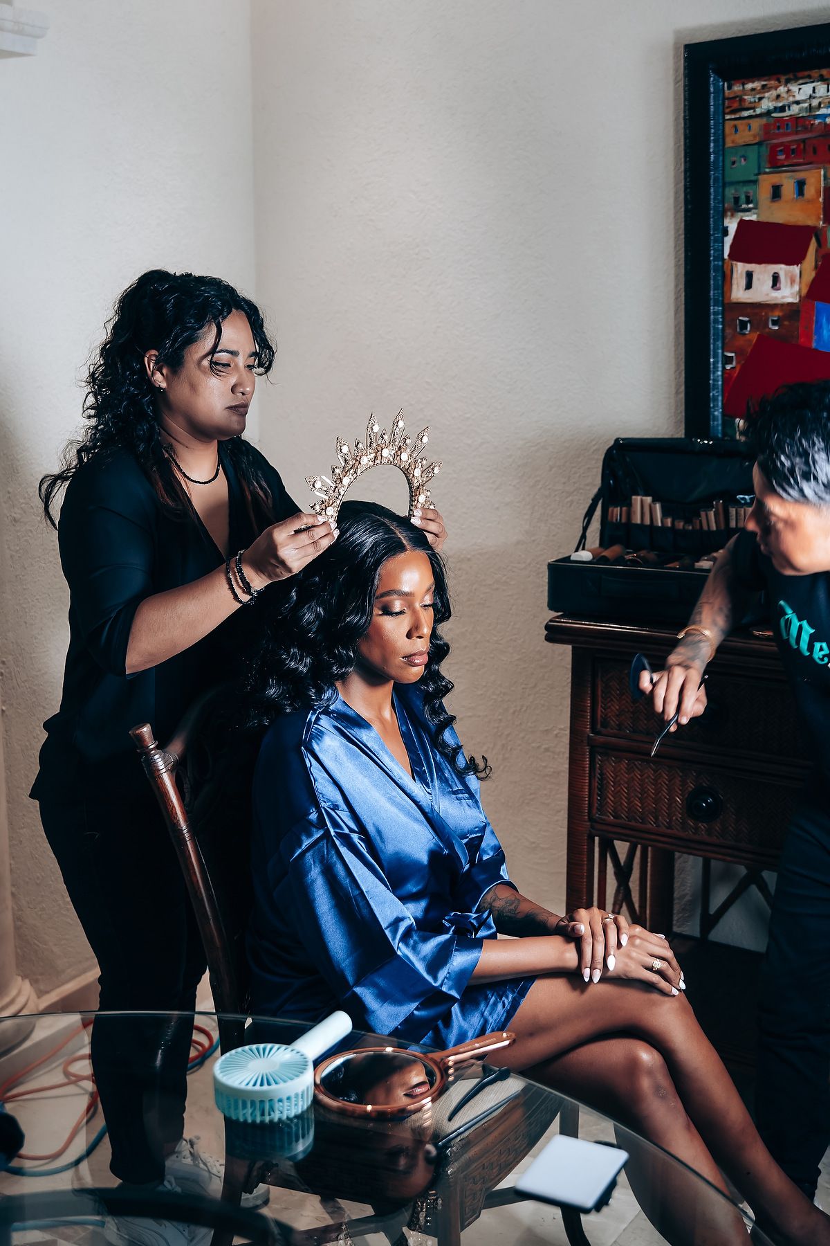 A series of intimate getting ready moments in a blue shirt against a wall with vintage decor.