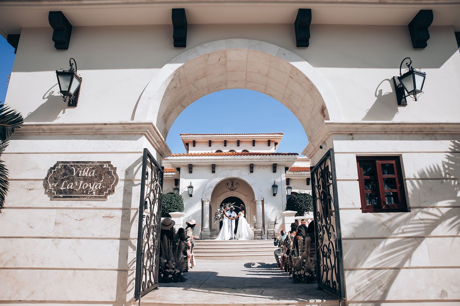 Mediterranean style venue exterior with arched walkways and decorative railings.