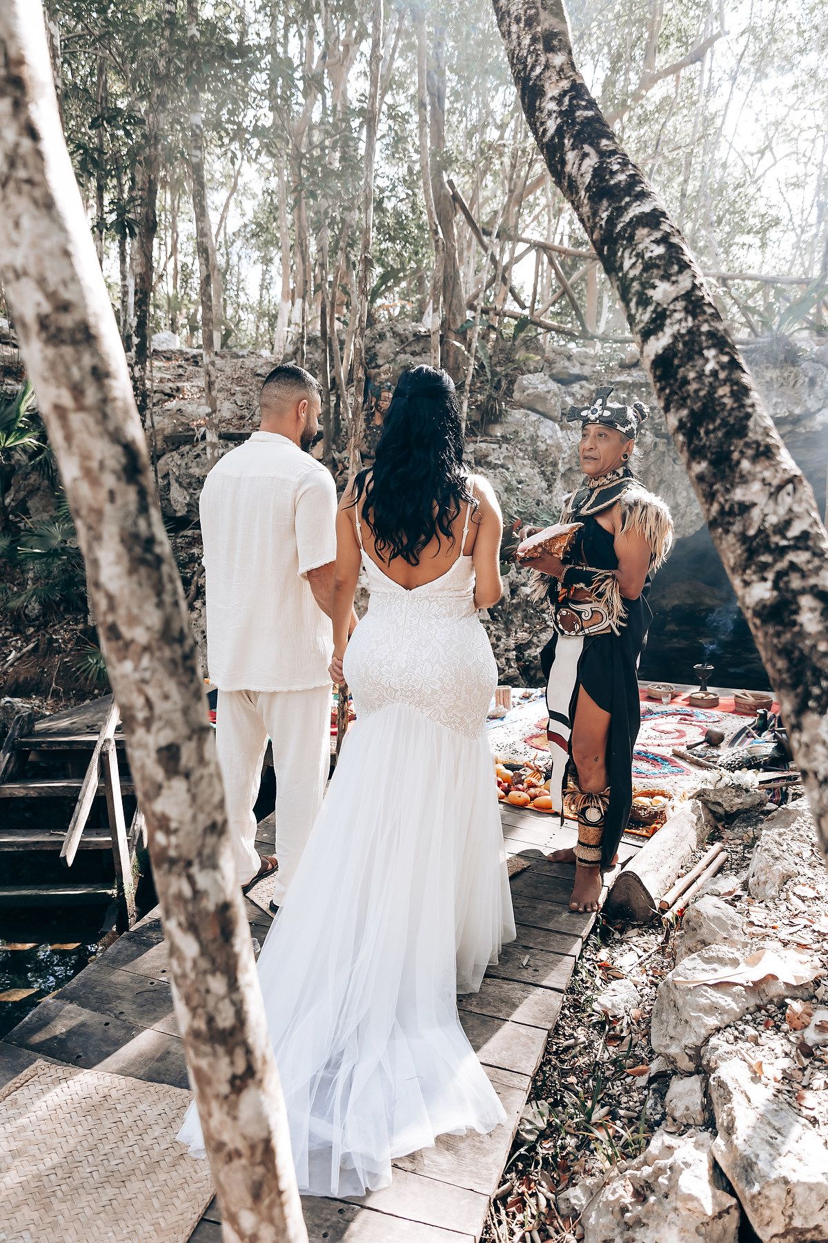 A sequence of wedding photos showing people walking through a birch forest path in white dresses and formal attire.