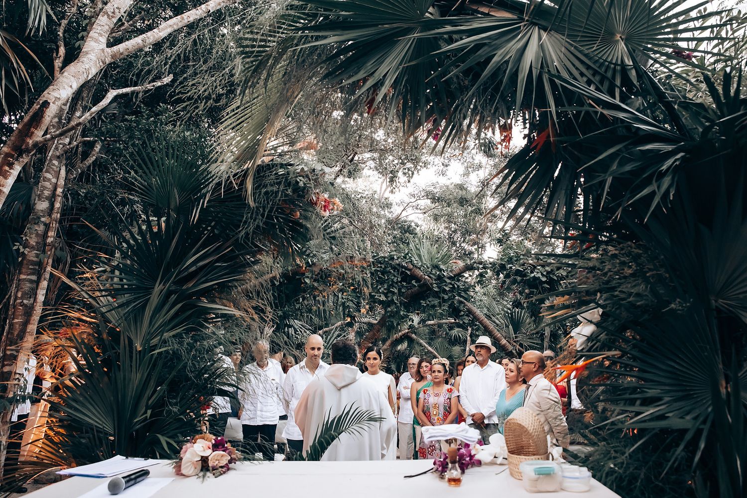 Palm trees line a tropical outdoor walkway with festive lighting and decorative elements.