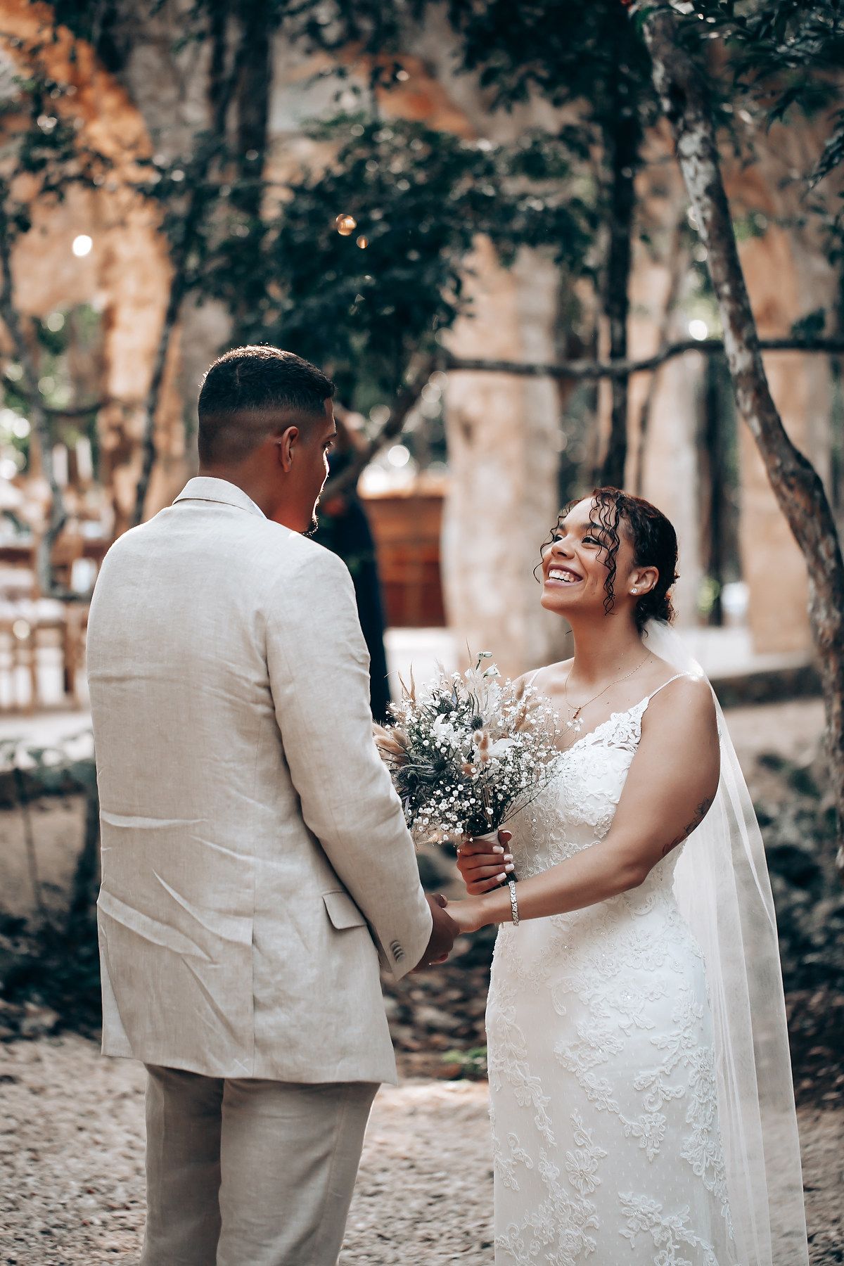 Couple sharing a joyful moment during their outdoor wedding ceremony.