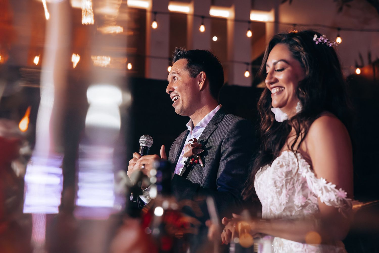 Reception celebration with warm lighting and joyful atmosphere.