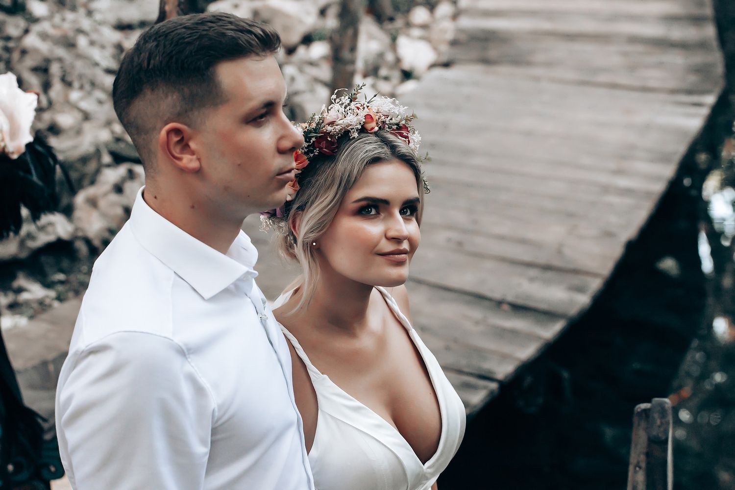 Couple sharing a romantic moment in an outdoor forest setting.