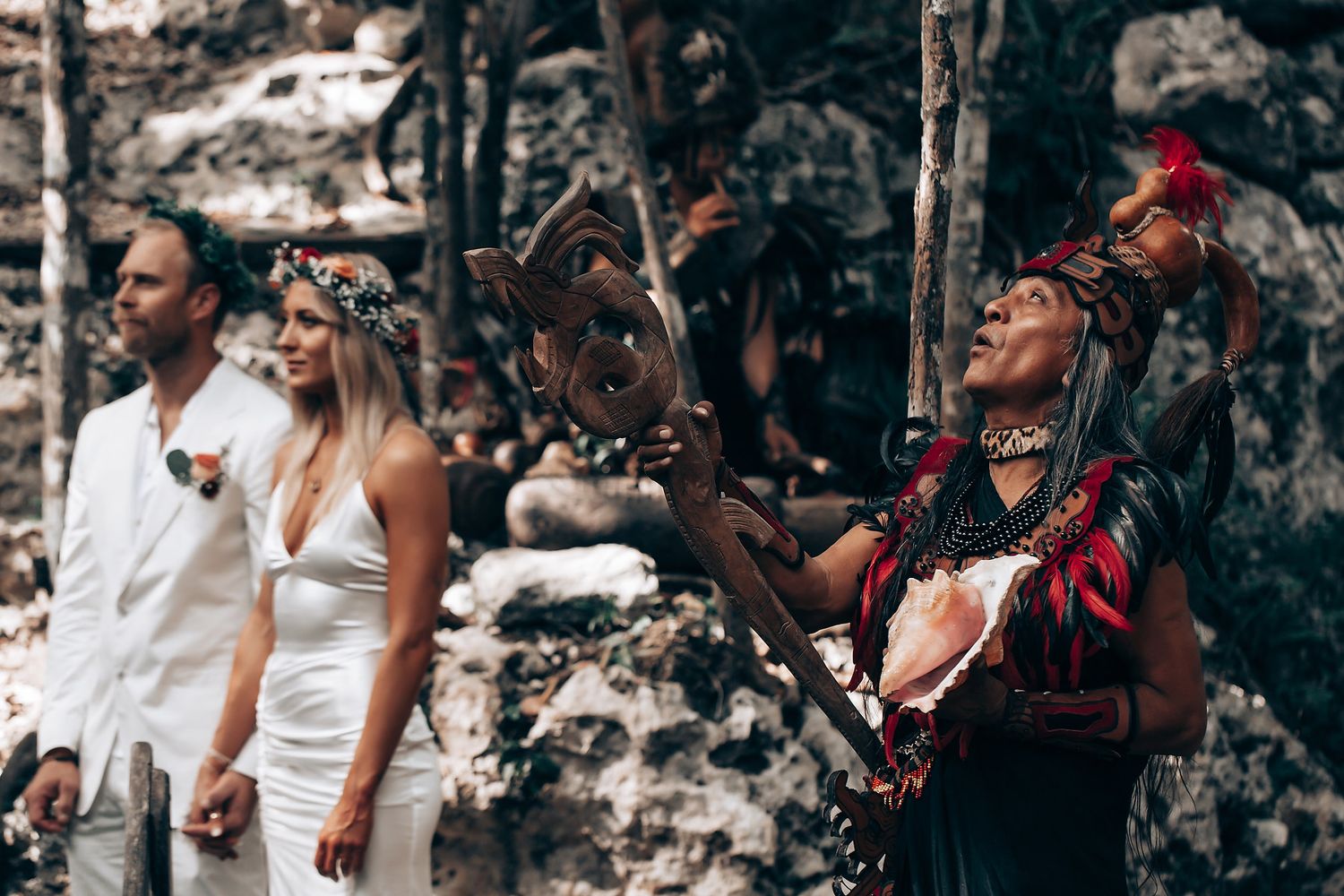 Group participating in traditional Mayan ceremony with musicians and attendees in white clothing.