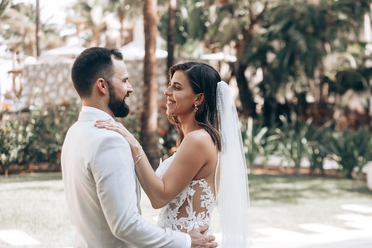 A couple shares intimate moments in a lush garden setting during their wedding photoshoot.