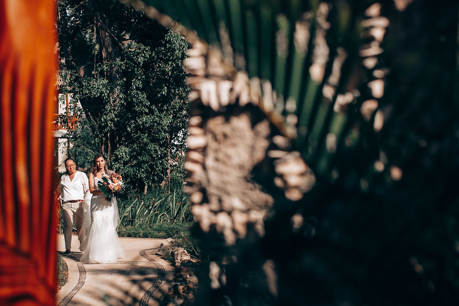 Artistic wedding photos with dramatic lighting showing silhouettes against a stone wall background.