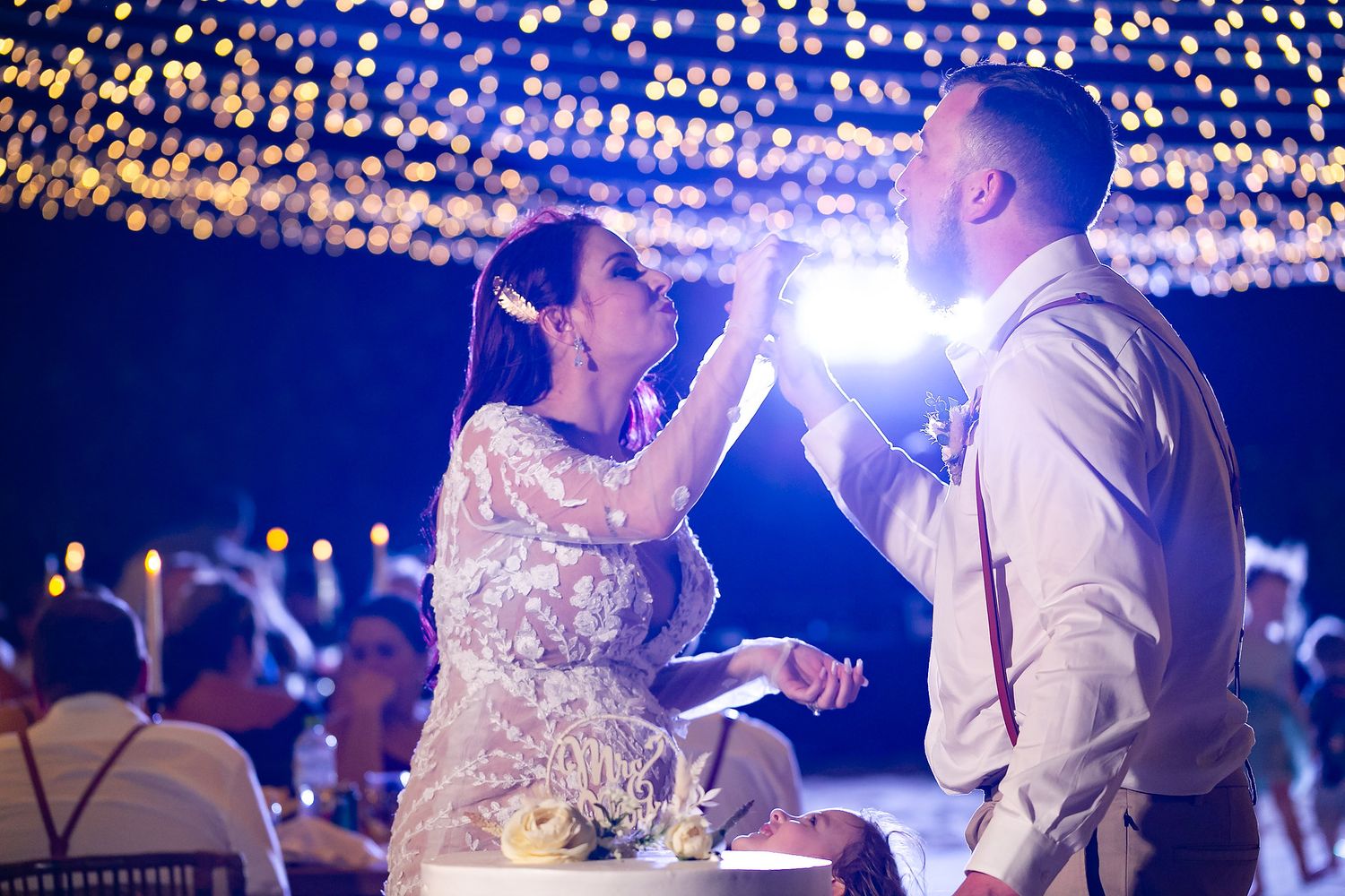 Wedding reception at night with twinkling string lights creating a magical atmosphere on the dance floor.