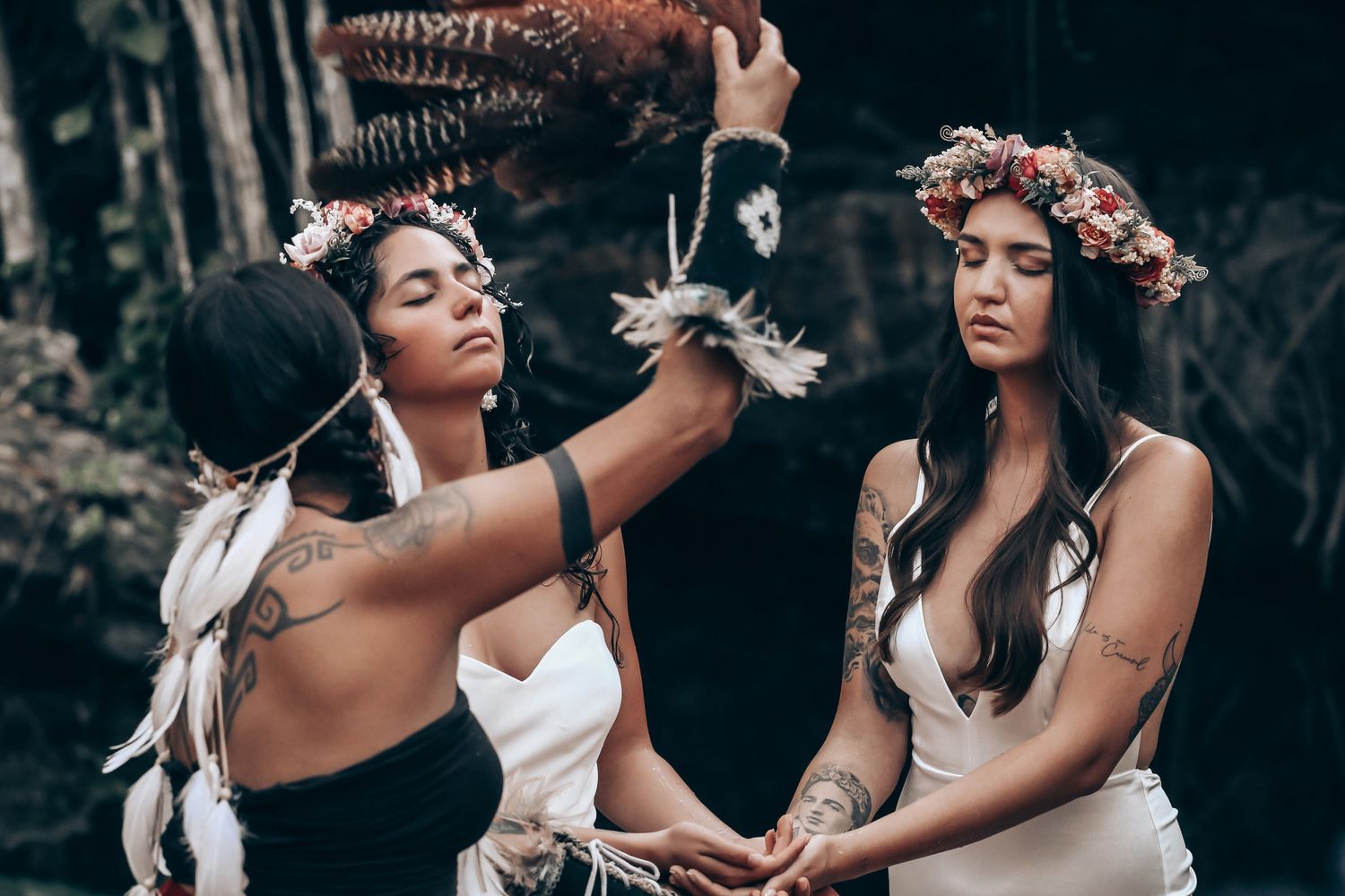 A romantic photoshoot captures tender moments between two people in a forest setting.