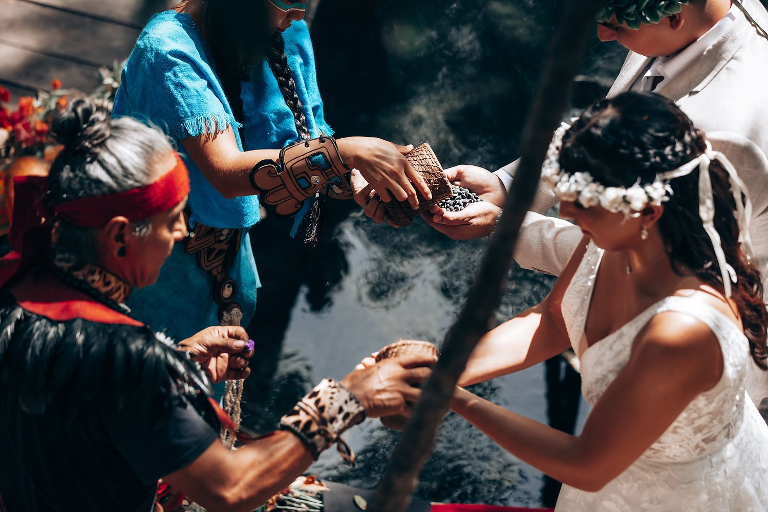Wedding celebration with attendees in turquoise and white attire amid forest surroundings.