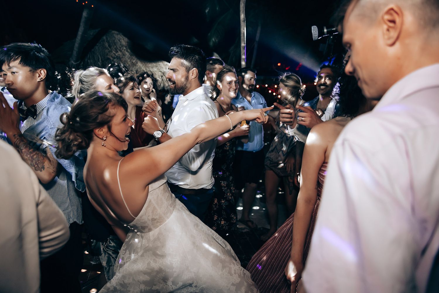 Wedding reception dance party with confetti and energetic celebrations.