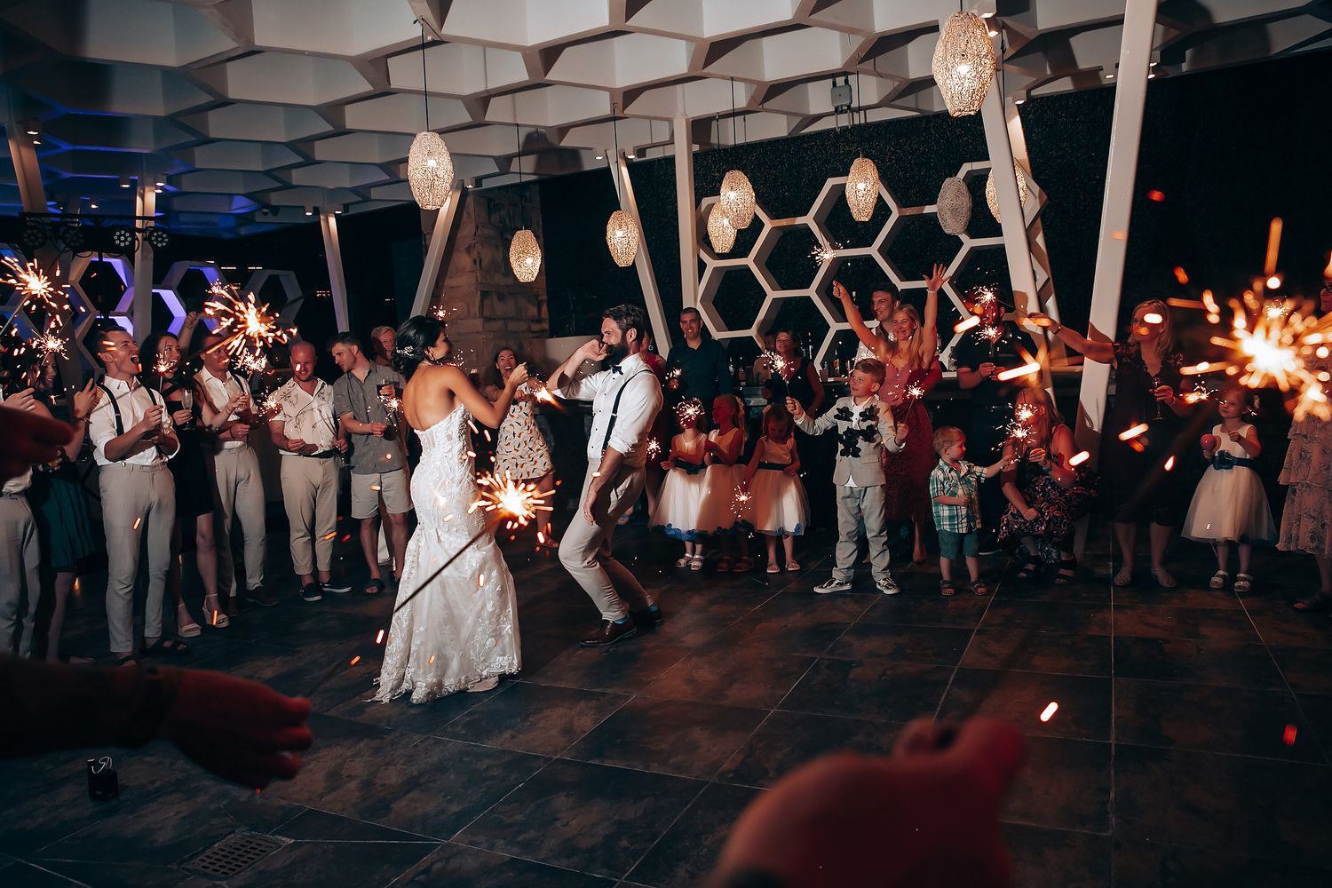 Wedding reception dance floor lit up at night with guests celebrating.