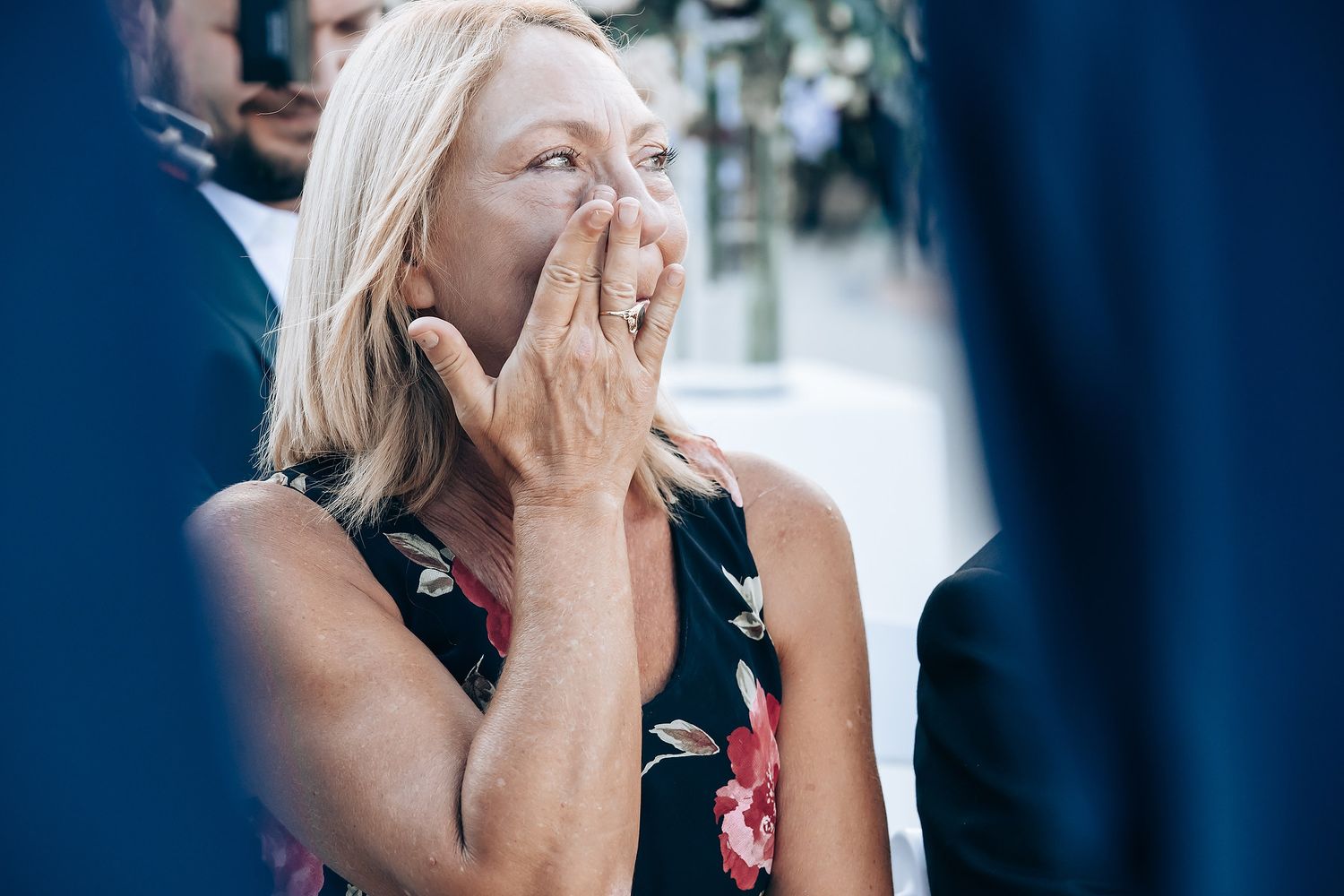 A woman appears to be crying or emotional during a wedding ceremony.