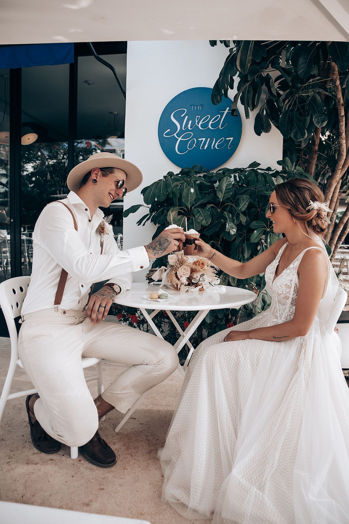 Wedding photo session at a beach-themed venue with white decor and casual tropical styling.