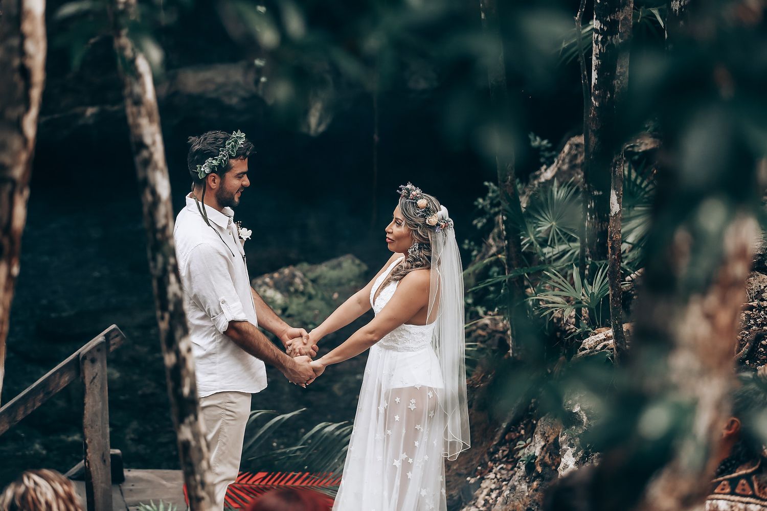 A couple exchanges vows during an intimate forest wedding ceremony.