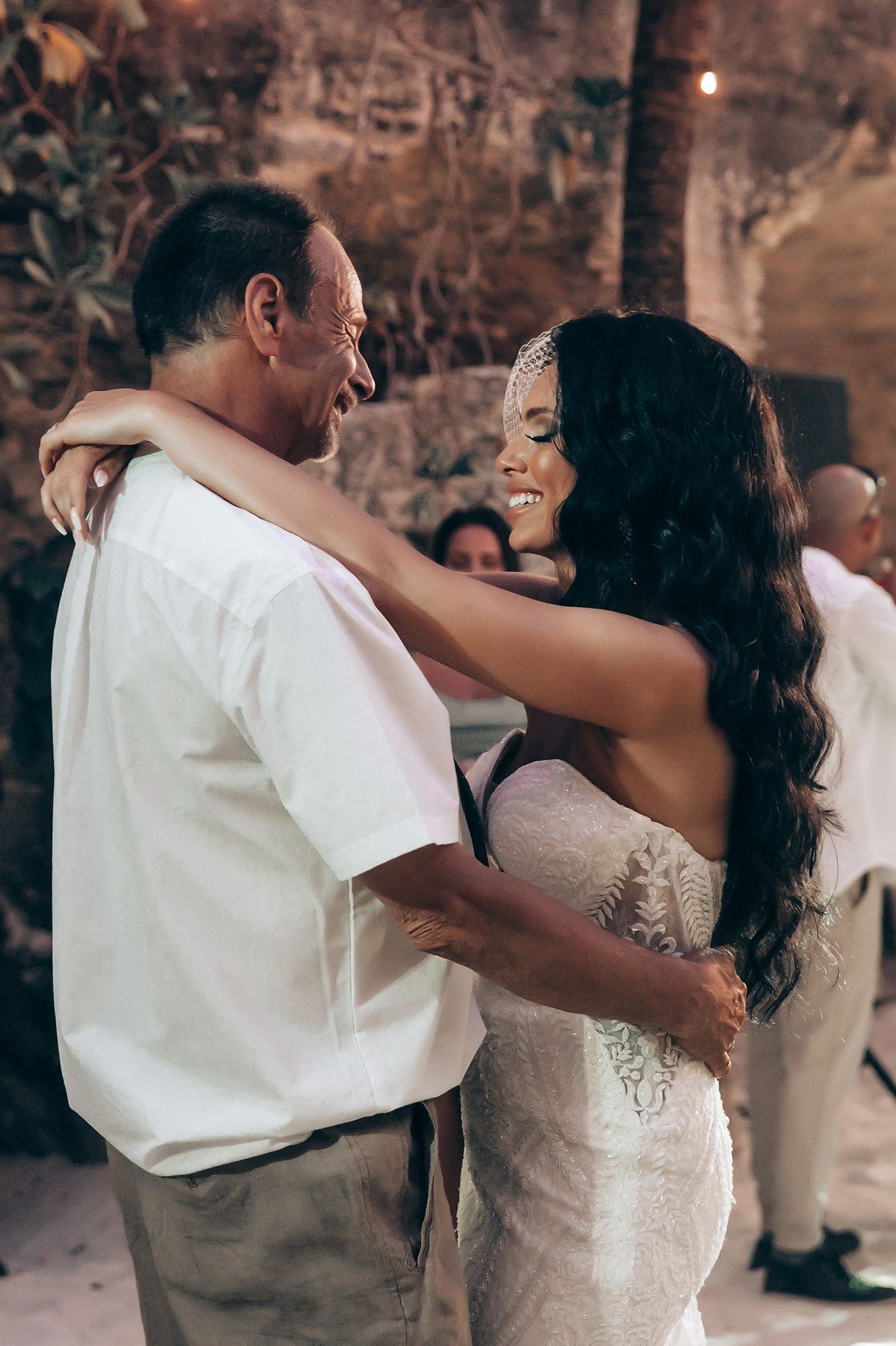 A couple shares an intimate dance moment at their wedding reception.