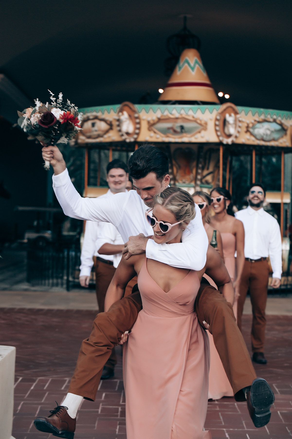 Wedding party performs choreographed dance routine in coordinated white and brown outfits.