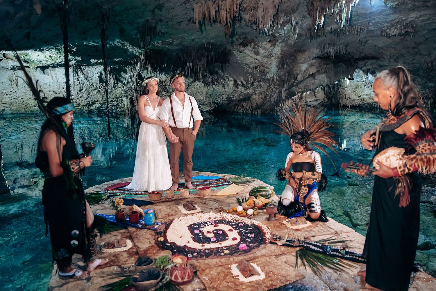 Intimate gathering inside a cave with tables set up for a special celebration.